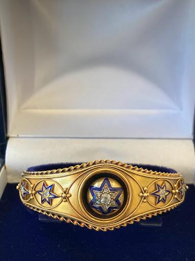 A Victorian gold bangle, blue enamel stars, brought back to wearable life.