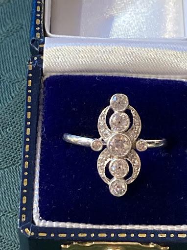 An old diamond panel ring, the kind a chain shop sends away.