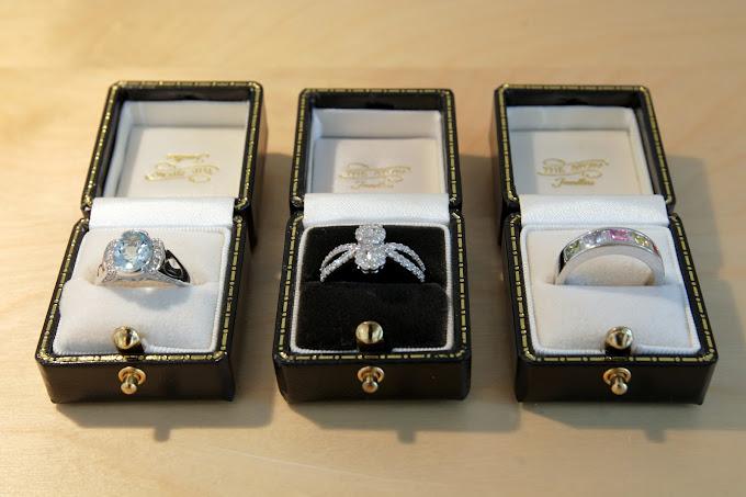 Aquamarine, diamond and multi-gem rings, boxed in Talbot Court.